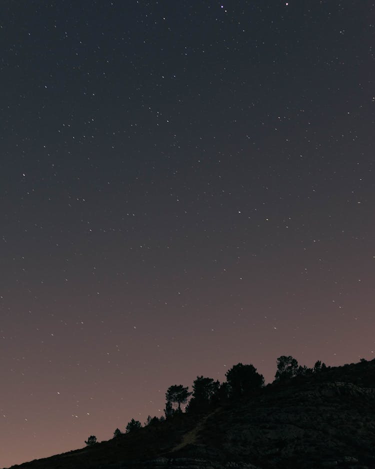 Stars On Sky Over Hill In Evening