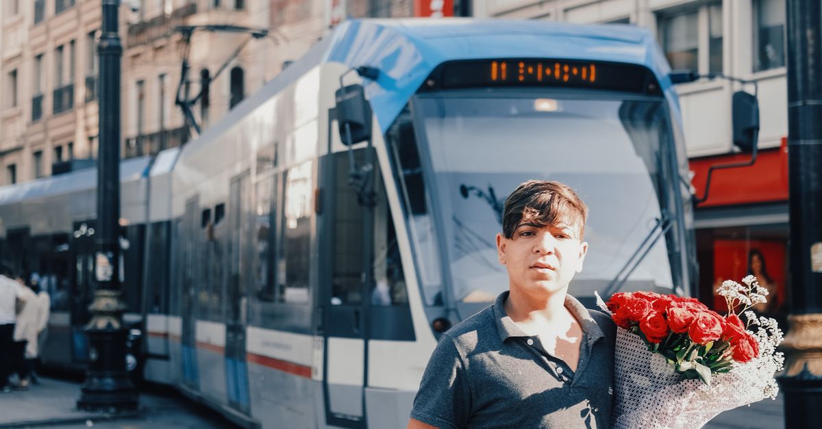 Man Carrying Roses A Man Carrying Bouquet of Red Roses · Free Stock Photo