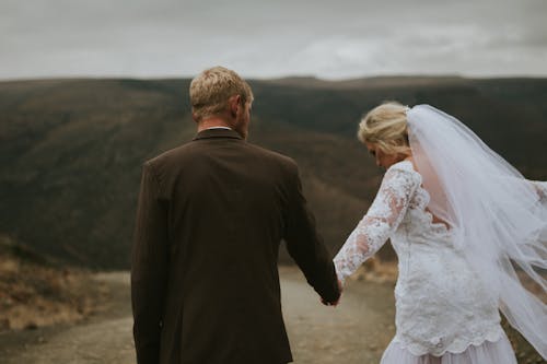 Newlyweds Walking on Dirt Road