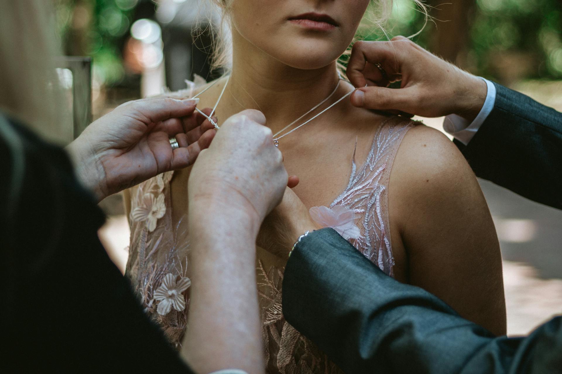 Hands Correcting Womans Necklace