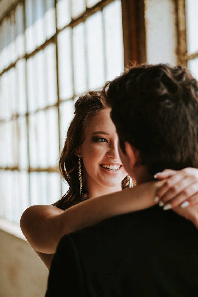 Smiling Woman Resting Her Hands On Man's Nape 