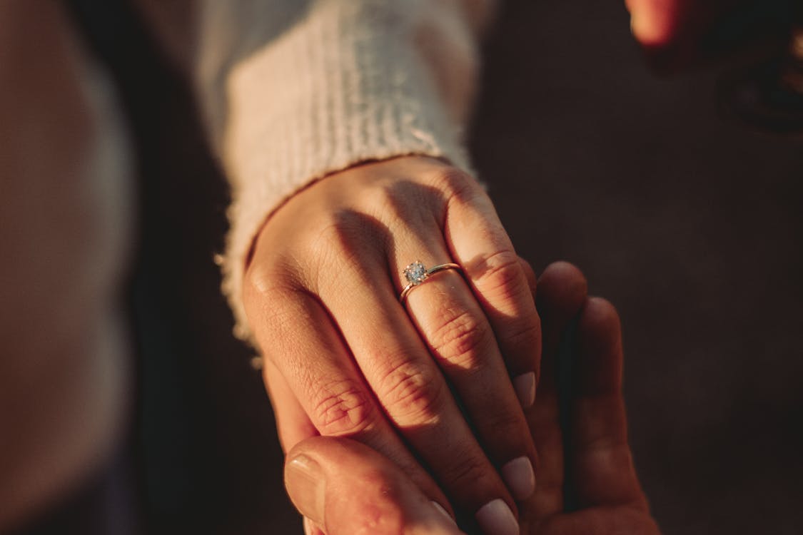 Free Close-up View of Man Holding Woman Hand with Ring Stock Photo