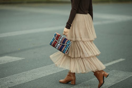 Person in Brown Skirt Crossing the Street