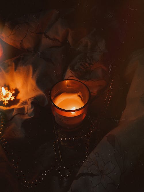 Free Photograph of a Lit Candle in a Brown Container Stock Photo