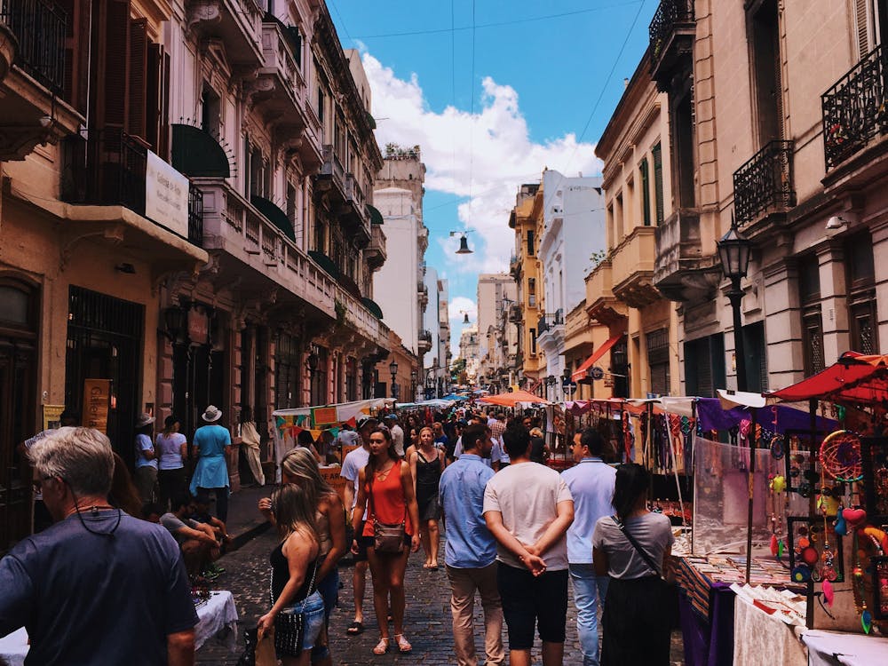 Gratis Gente De Pie En La Carretera Junto Al Mercado Y Edificios De Gran Altura Foto de stock