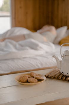 A cozy scene with cookies and a teapot, capturing a tranquil morning vibe indoors.