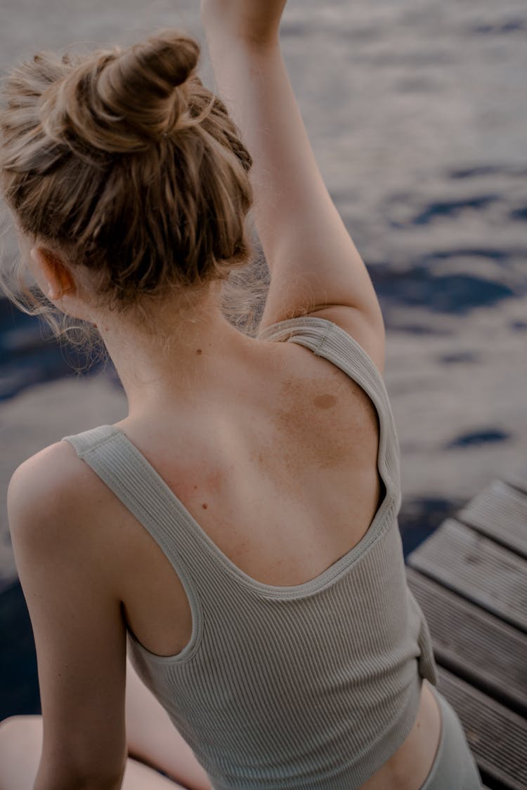 Blond Woman Sitting On Pier