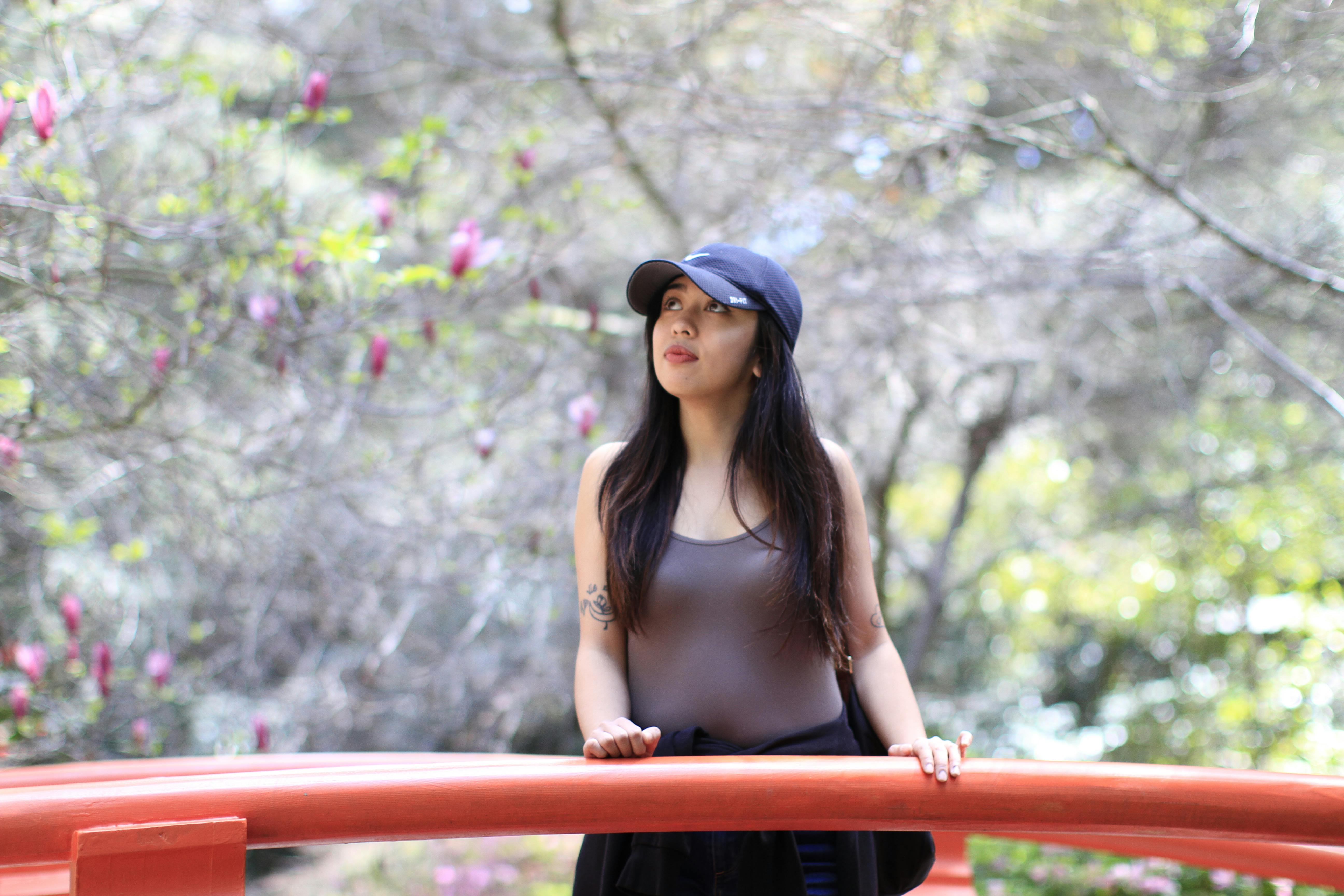 woman in gray tank top and black cap