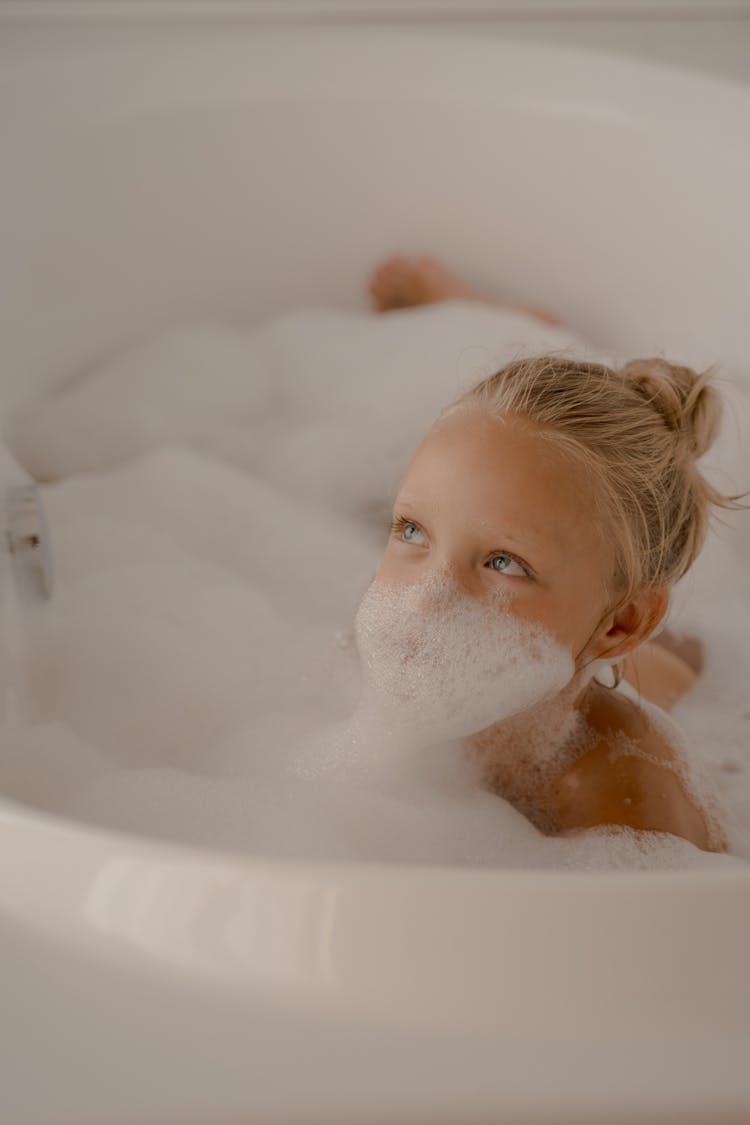 Little Blond Girl Playing With Foam During Bubble Bath