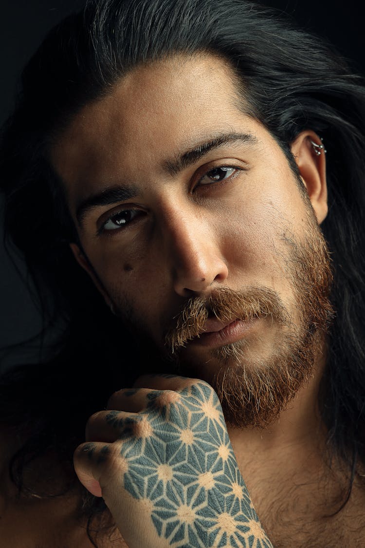 Man With Facial Hair, Piercings And Tattoo