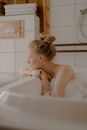 Woman in Bathtub Looking Away