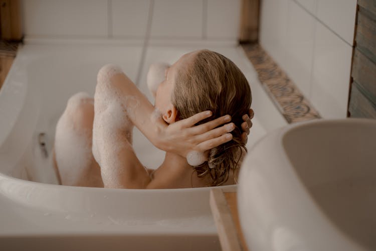 Woman Taking Bath With Bubbles