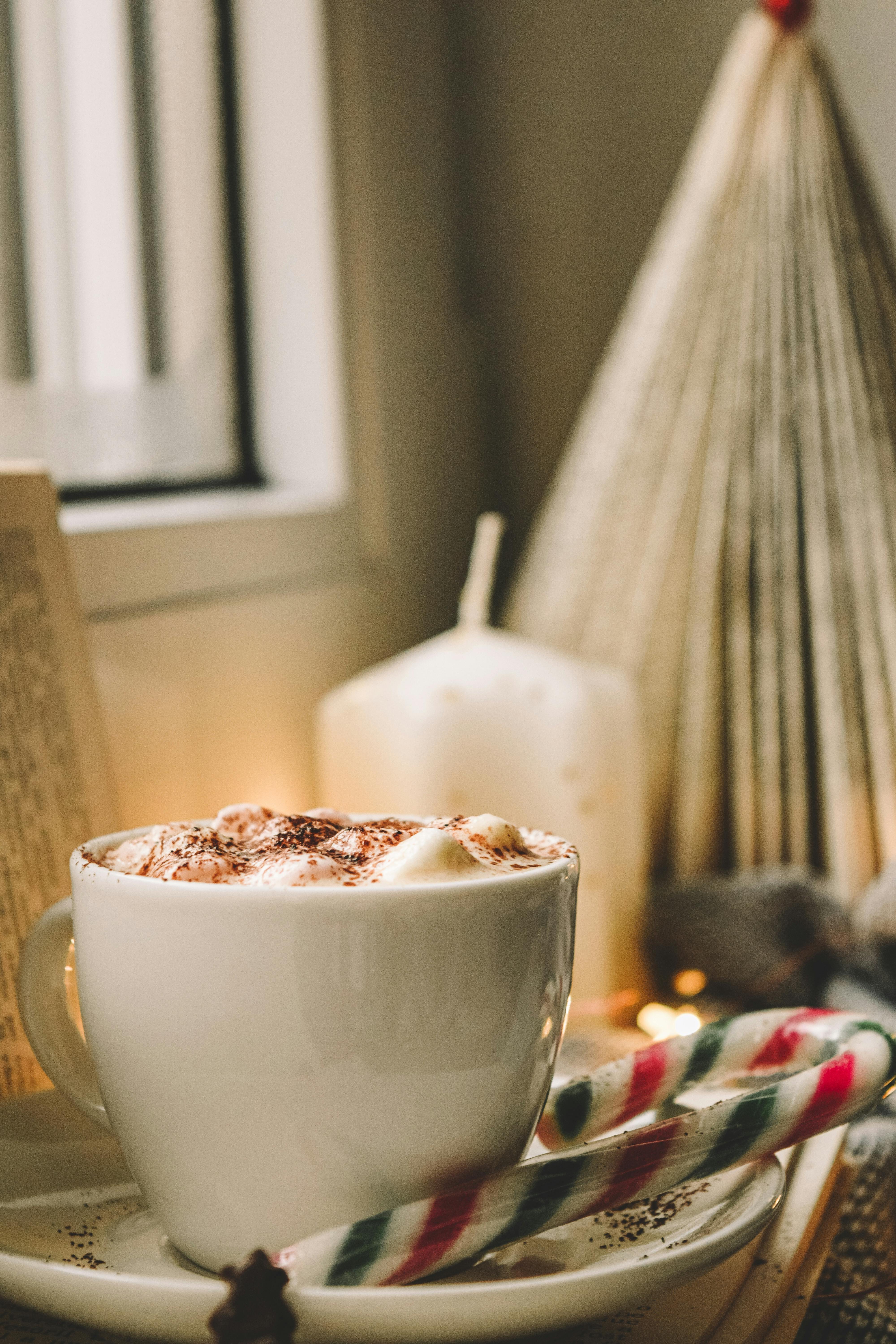 white ceramic mug with brown liquid