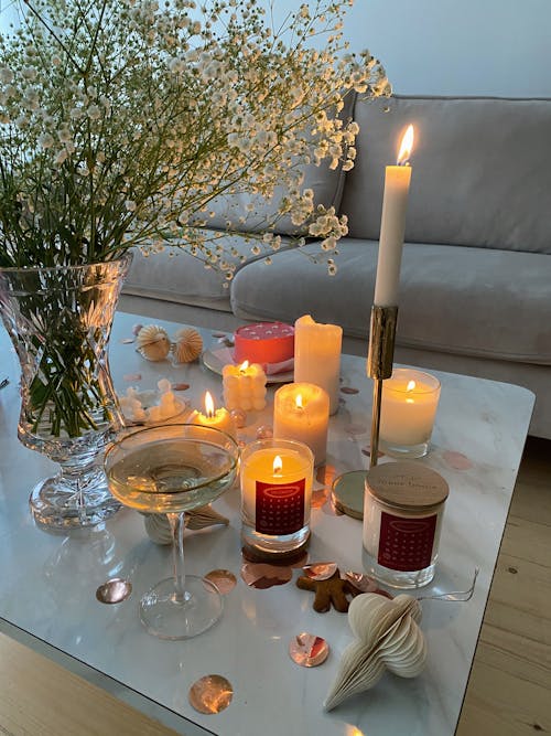 Candlelight on White Table beside Clear Flower Vase