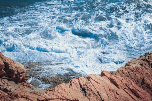 Brown Rock Formation Beside Body of Water