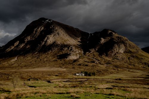 Free A dramatic landscape showcasing a majestic mountain with a stormy sky backdrop. Stock Photo
