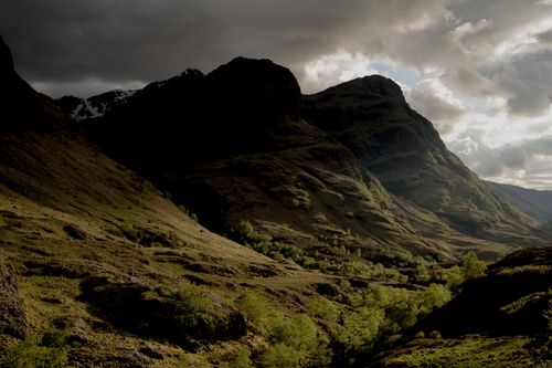 Free A breathtaking view of a mountainous landscape under a dramatic cloudy sky. Stock Photo