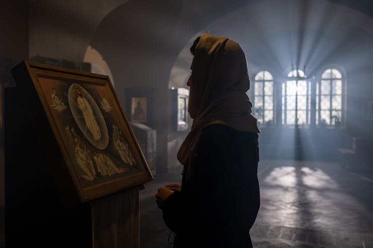 Woman Looking At Icon In Church 