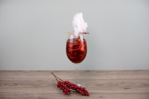 Wineglass with Red Liquid and Pink Cotton Candy