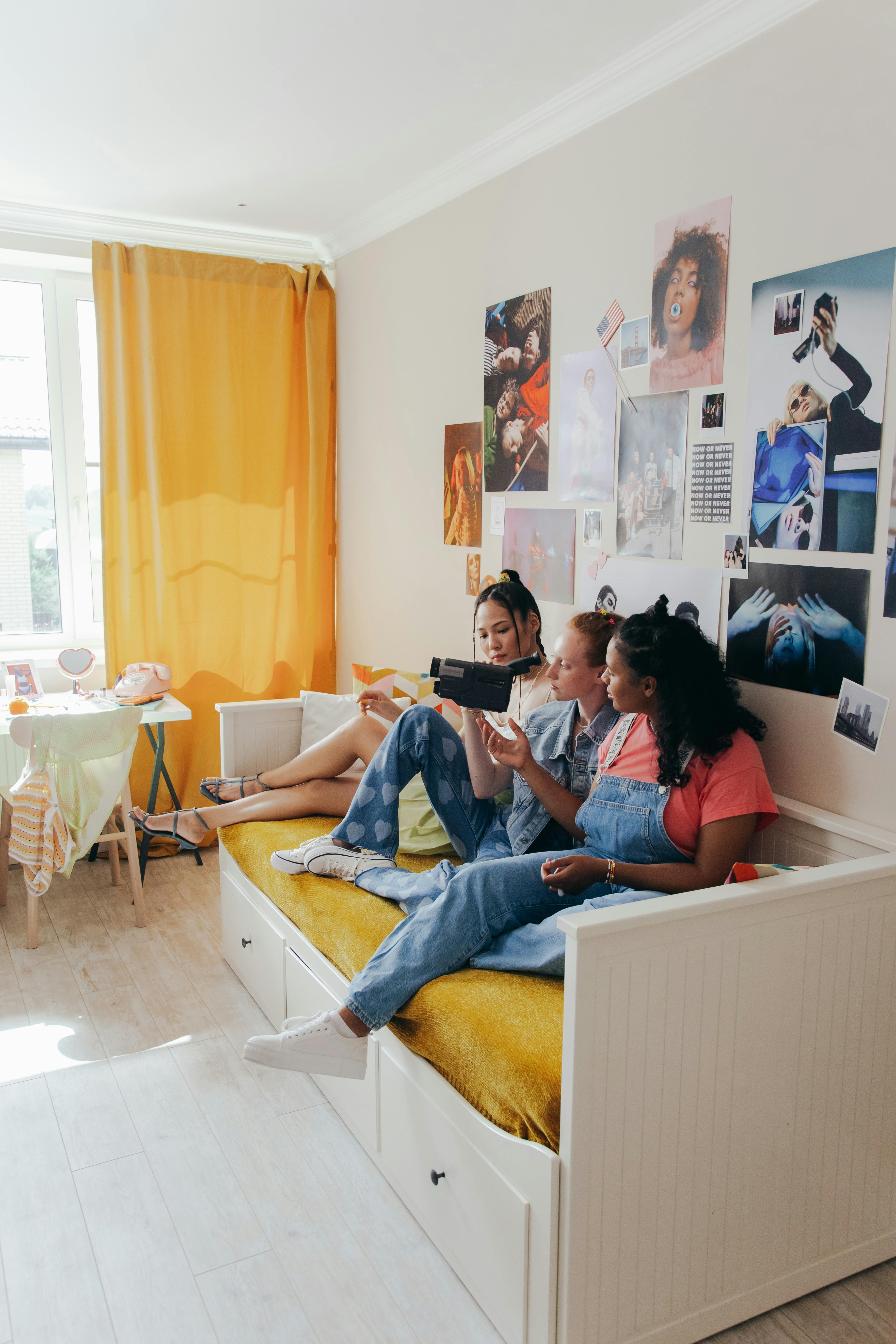 teenagers sitting on a bed
