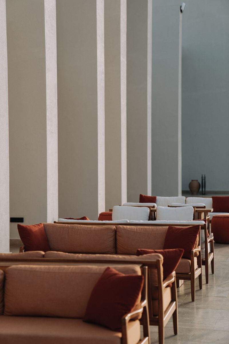 Minimalist interior with modern couches and a vertical wall detail — photo by alleksana on Pexels