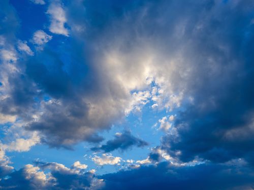 Free Beautiful view of dense clouds with vibrant blue sky breaking through, perfect for atmospheric themes. Stock Photo