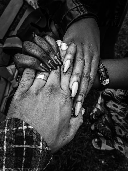 Free A close-up black and white image of diverse hands joined together symbolizing unity and community. Stock Photo