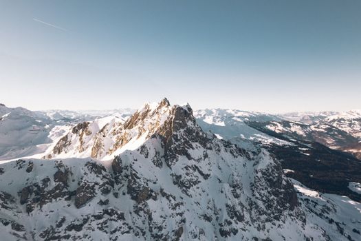 Majestic snowy mountains in Klosters-Serneus, Switzerland, under a clear blue sky.