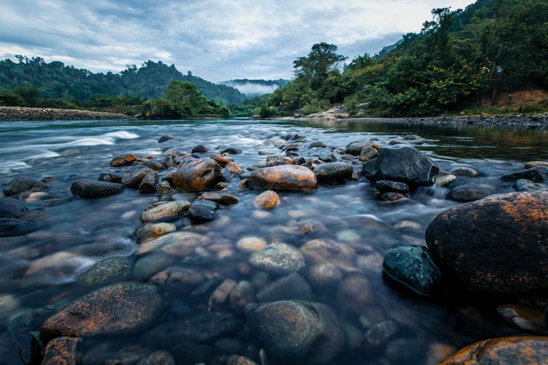 A mountain river with flowing water and rocks.