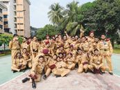People in Brown Uniform Sitting on Concrete Bench