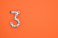 在充满活力的橙色背景下，自行车链位列第三，提供了充足的版权空间