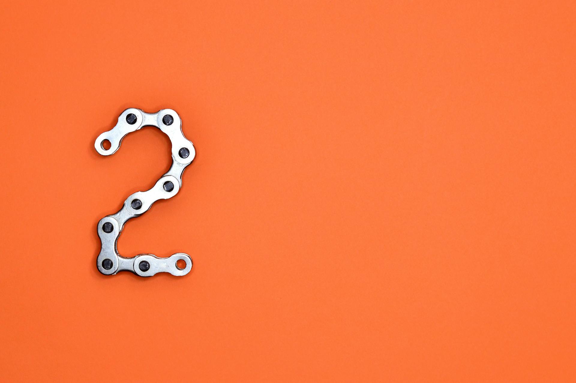 Gray Steel Chain on Orange Surface