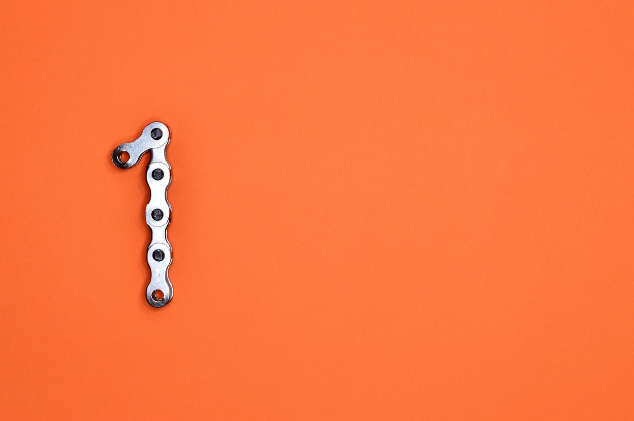 metal chain forming the number one on an orange background ideal for d