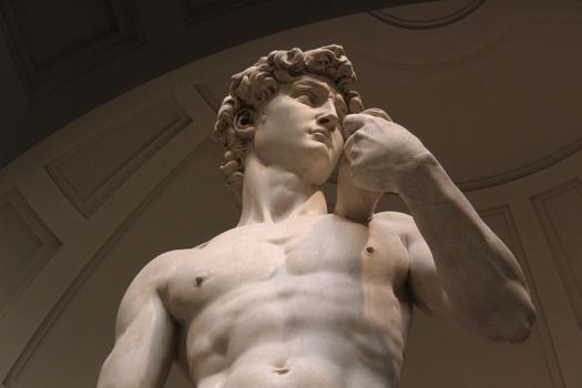 A low-angle view of Michelangelo's iconic David statue, showcasing Renaissance art.