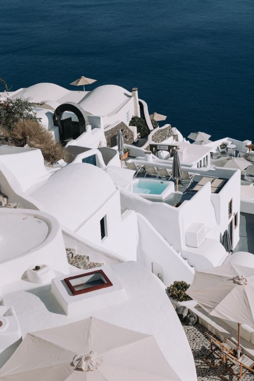 Free Stunning view of Santorini's iconic white-washed buildings and azure sea under the clear sky. Stock Photo