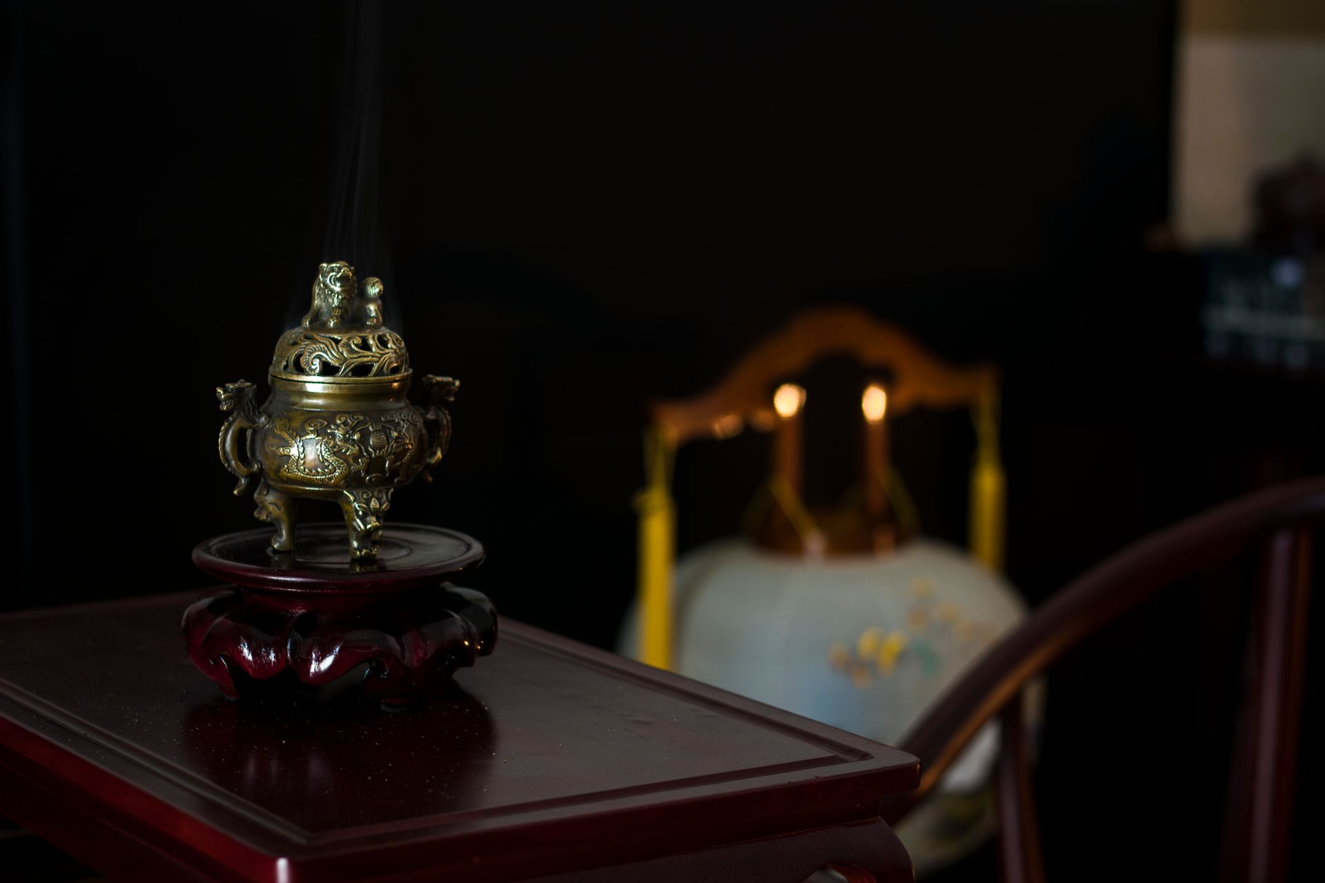 Close-up of a brass incense burner and candles, creating a serene atmosphere.