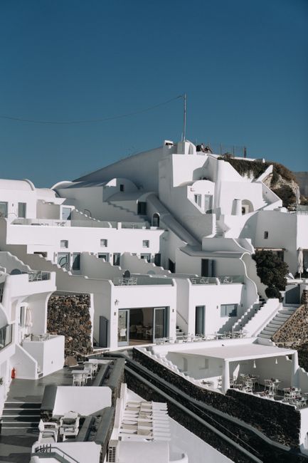 Breathtaking panorama of Santorini's distinct white buildings under a clear blue sky.