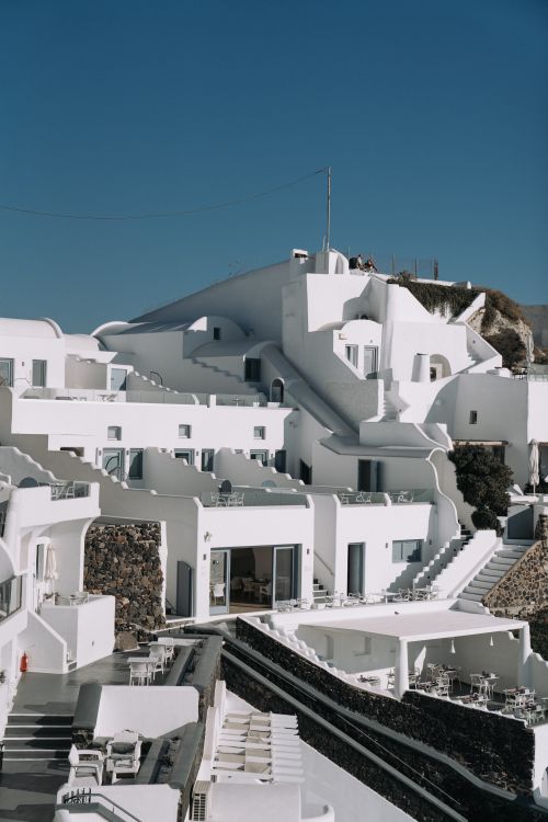 Free Breathtaking panorama of Santorini's distinct white buildings under a clear blue sky. Stock Photo