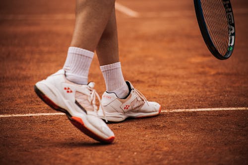 Person Wearing White and Red Sneakers