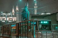 Green and Brown Tram in City during Night Time