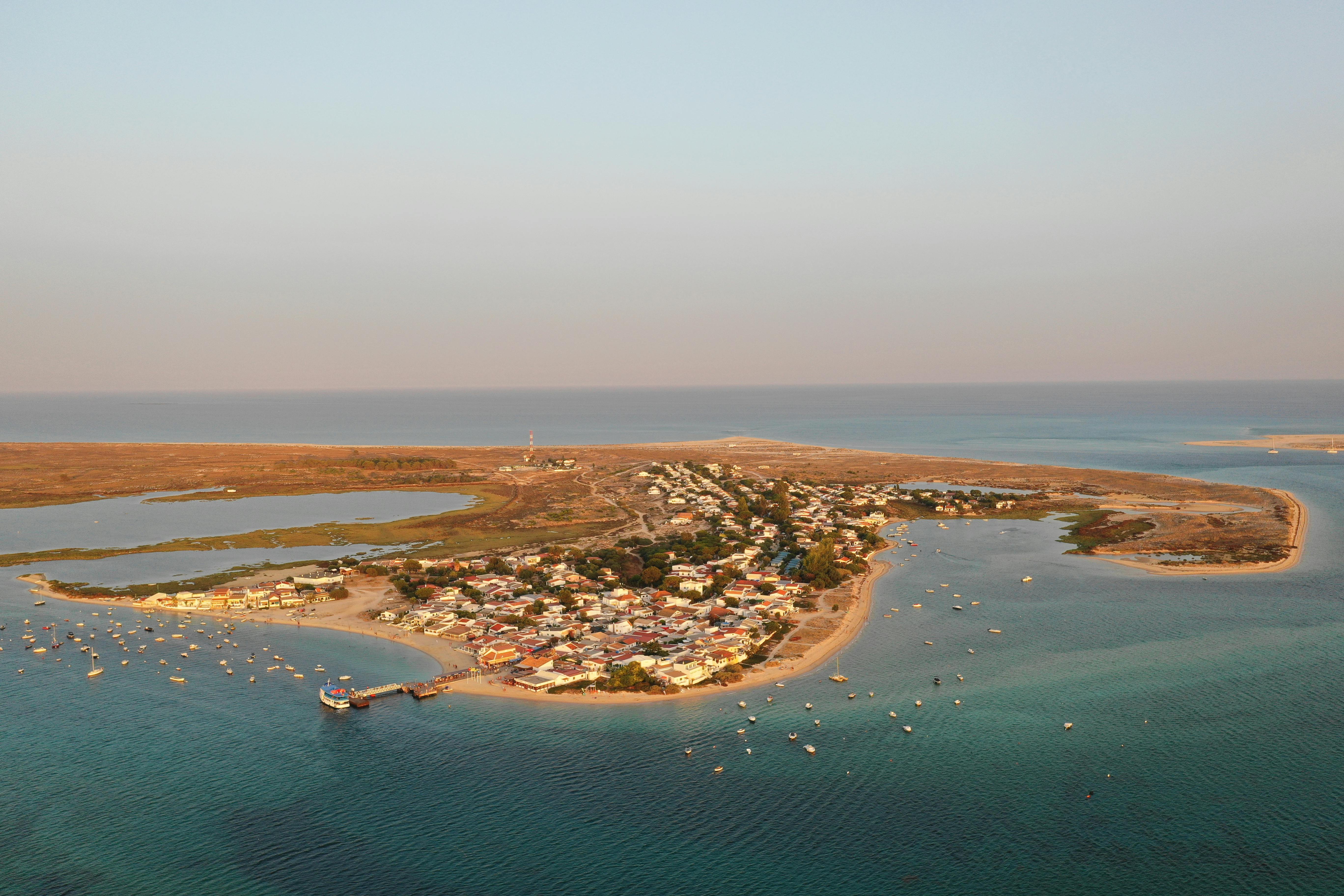 Stunning aerial shot of a coastal town in Olhão, Portugal, at sunset.