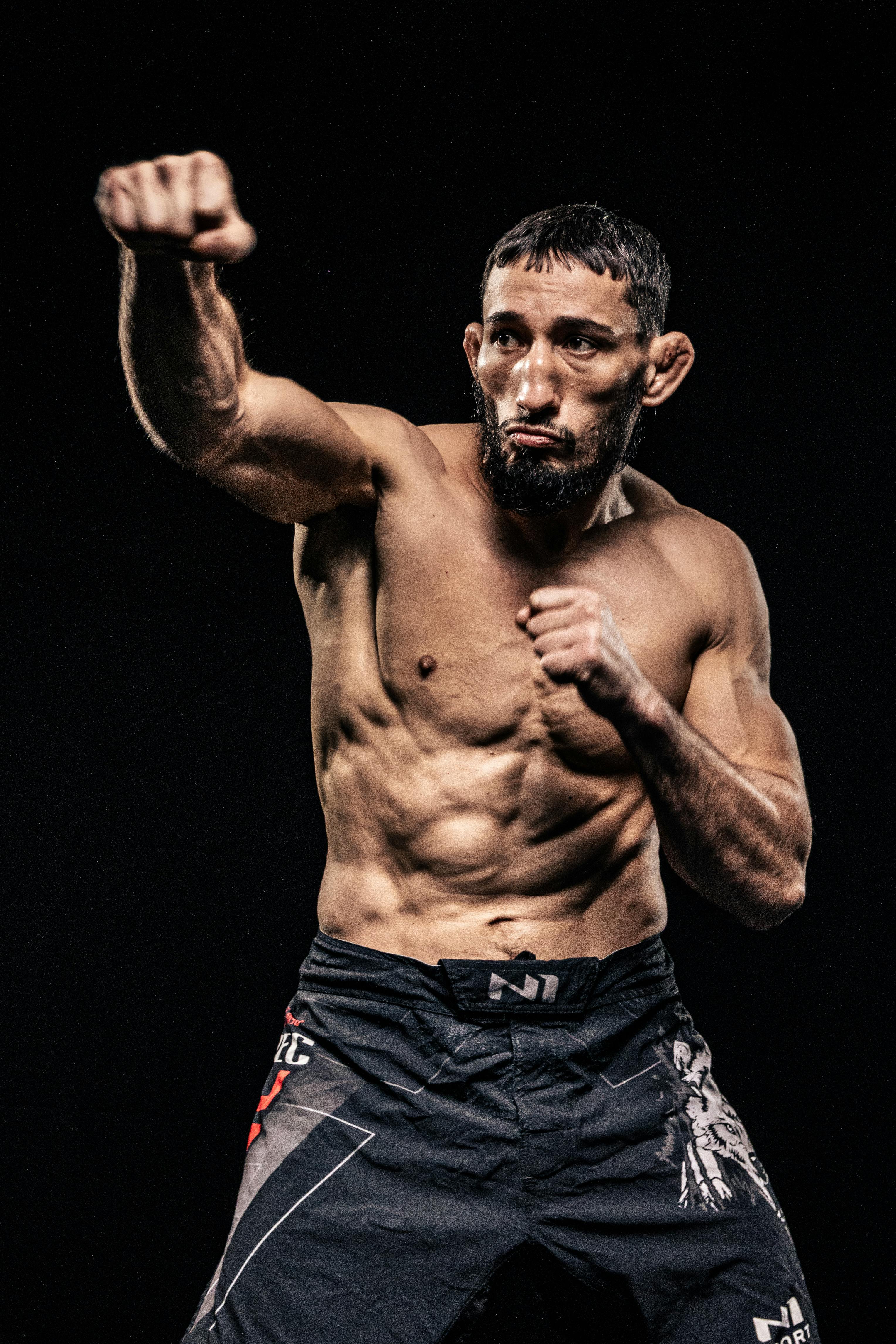 Athletic man in a boxing stance showcasing muscular physique and determination.