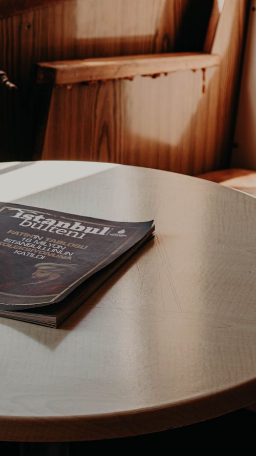 Free Warm interior shot of a coffee table in Istanbul featuring a magazine and ambient sunlight. Stock Photo