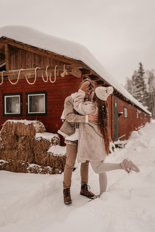Couple Standing on Snow and Hugging