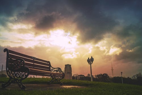 Black Steel Frame Brown Wooden Bench during Daytime