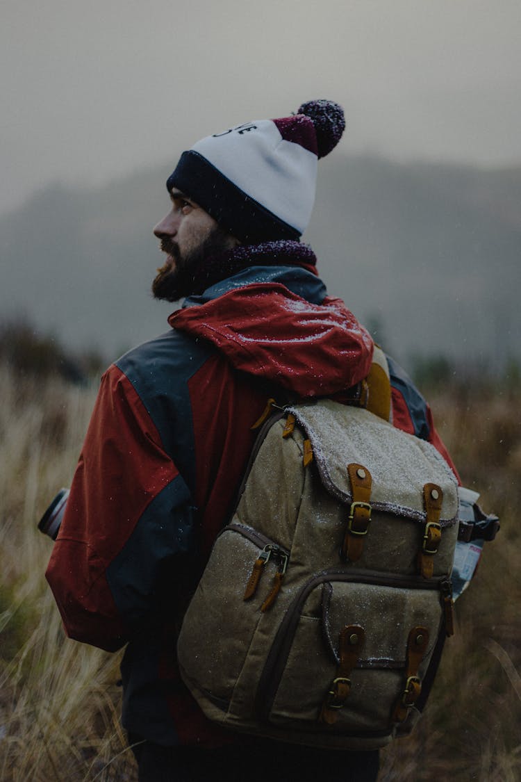 Man With Backpack In Snow