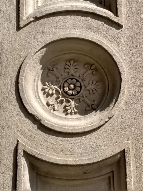 Free Close-up of a detailed bas relief showing intricate carving on a stone facade. Stock Photo