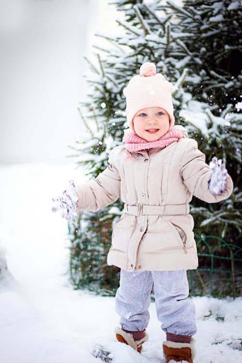 Toddler Standing on Snow-Covered Ground