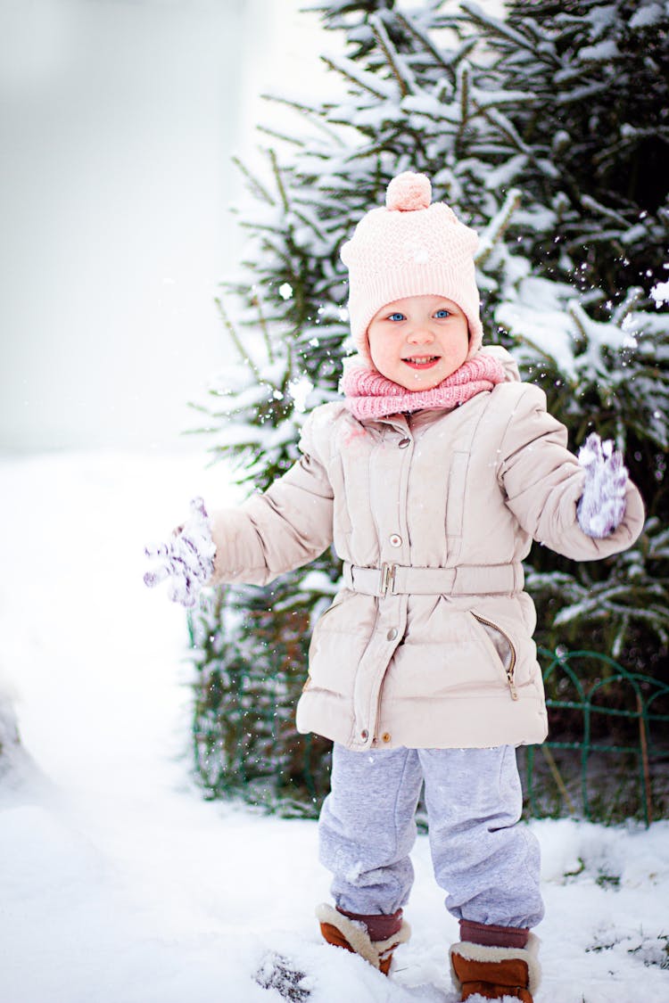 Toddler Standing On Snow-Covered Ground