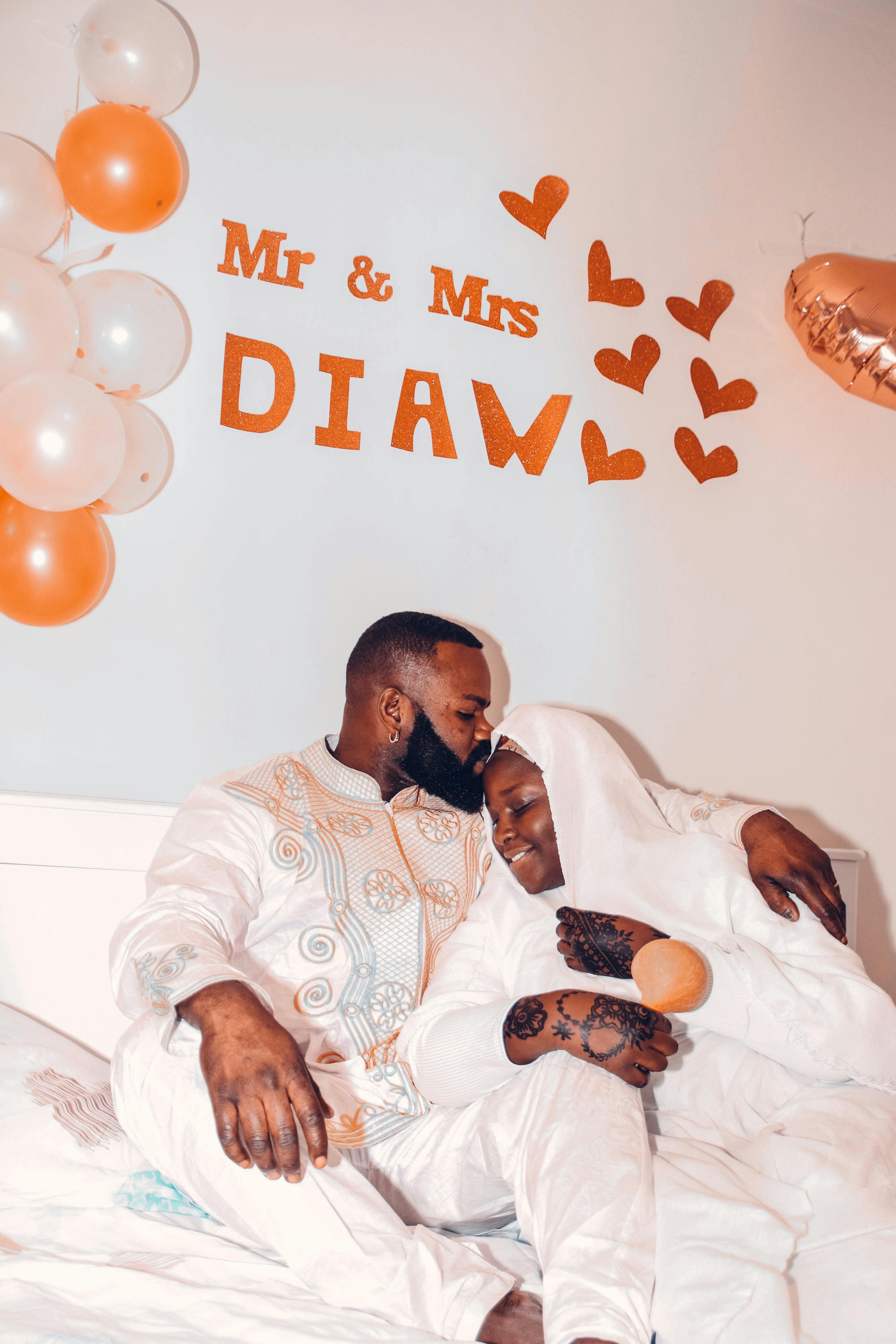A loving Muslim couple embraces during their intimate indoor wedding celebration.